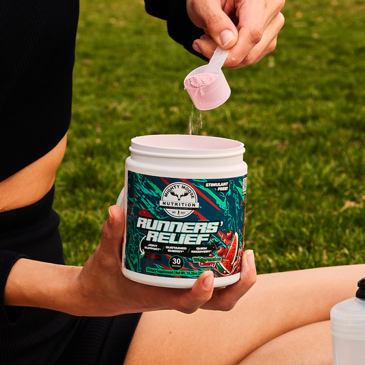 A runner scooping Runners' Relief tart cherry recovery mix outdoors